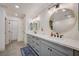 Bathroom with double sinks, grey cabinetry, and round mirrors at 189 Andada Dr, Henderson, NV 89012