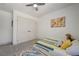 Bright bedroom with soft carpet, features a decorative rug and large closet with white doors at 189 Andada Dr, Henderson, NV 89012