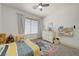 Bright bedroom with plush carpet, ceiling fan, dresser and playful decor at 189 Andada Dr, Henderson, NV 89012