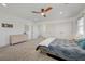 Neutral bedroom featuring ensuite access, dresser, carpet, and ceiling fan at 189 Andada Dr, Henderson, NV 89012