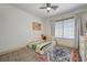 Cozy bedroom featuring a ceiling fan, plush carpeting, and a vibrant rug at 189 Andada Dr, Henderson, NV 89012