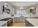 Bright kitchen with stainless steel appliances, white countertops, and gray cabinets at 189 Andada Dr, Henderson, NV 89012