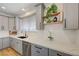 Modern kitchen featuring white countertops, stainless steel appliances, and gray cabinets at 189 Andada Dr, Henderson, NV 89012