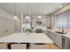 Modern kitchen features stainless steel appliances, a large island with seating, and gray cabinets at 189 Andada Dr, Henderson, NV 89012