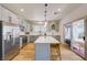 Modern kitchen featuring gray cabinets, stainless steel appliances, and a center island at 189 Andada Dr, Henderson, NV 89012