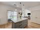 Kitchen island opens to backyard and a living room with fireplace, creating a nice flow at 189 Andada Dr, Henderson, NV 89012