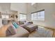 Spacious living room featuring a comfortable sectional sofa, lots of light, and kitchen view at 189 Andada Dr, Henderson, NV 89012
