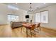 Open-concept living area with fireplace, dining area, modern chandelier and ample natural light at 189 Andada Dr, Henderson, NV 89012