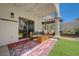 Comfortable covered patio with rug, bench seating, hanging hammocks and manicured artificial turf at 189 Andada Dr, Henderson, NV 89012