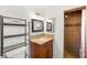 Bathroom with granite countertop, vanity, tiled shower, and ample shelving at 1901 Manhattan Dr, Las Vegas, NV 89106