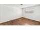 A bright bedroom features hardwood floors, neutral walls, and a window for natural light at 1901 Manhattan Dr, Las Vegas, NV 89106