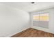 A bright bedroom features hardwood floors, neutral walls, and a window for natural light at 1901 Manhattan Dr, Las Vegas, NV 89106