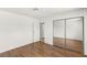 A lovely bedroom featuring a large closet with sliding mirrored doors and hardwood flooring at 1901 Manhattan Dr, Las Vegas, NV 89106