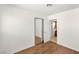 Bedroom featuring wood-look floors, light walls, closet, and adjacent bathroom at 1901 Manhattan Dr, Las Vegas, NV 89106