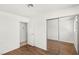 Bedroom featuring wood-look floors, light walls, closet, and adjacent bathroom at 1901 Manhattan Dr, Las Vegas, NV 89106