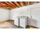 A utilitarian laundry room with washer, dryer and exposed wood beam ceiling at 1901 Manhattan Dr, Las Vegas, NV 89106