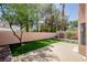 A serene backyard space with lush lawn, mature trees, and a privacy wall, perfect for relaxation at 2204 Brighton Shore St, Las Vegas, NV 89128