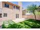 View of backyard with lawn, mature tree, patio, and low-maintenance landscaping at 2204 Brighton Shore St, Las Vegas, NV 89128