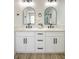 Bathroom boasts dual sinks, elegant marble countertop, framed arched mirrors and modern fixtures at 2204 Brighton Shore St, Las Vegas, NV 89128
