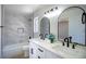 A bathroom features dual sinks, modern mirrors and fixtures, and a tiled shower/tub at 2204 Brighton Shore St, Las Vegas, NV 89128