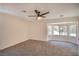 Spacious bedroom with neutral carpet and walls, featuring bright natural light from the bay window at 2204 Brighton Shore St, Las Vegas, NV 89128