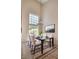 The dining room features a modern chandelier, glass table, and high ceilings at 2204 Brighton Shore St, Las Vegas, NV 89128