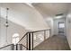 A hallway boasts modern railings and unique lighting fixtures on the upper floor at 2204 Brighton Shore St, Las Vegas, NV 89128
