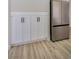 A view of the kitchen shows white cabinets with black handles and a stainless steel refrigerator at 2204 Brighton Shore St, Las Vegas, NV 89128
