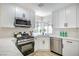 Bright kitchen features white quartz countertops, stainless appliances and modern finishes at 2204 Brighton Shore St, Las Vegas, NV 89128