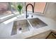 A close-up showcases a stainless steel kitchen sink with a black faucet and marble countertop at 2204 Brighton Shore St, Las Vegas, NV 89128