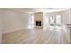 Living room featuring a fireplace with white tile surround and access to backyard at 2204 Brighton Shore St, Las Vegas, NV 89128