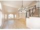 Open living room features vaulted ceiling, wood floors, a modern staircase, and bright natural light at 2204 Brighton Shore St, Las Vegas, NV 89128