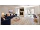 Bright living room with fireplace, blue sofa, and access to the backyard at 2204 Brighton Shore St, Las Vegas, NV 89128