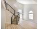 Bright living room with a modern staircase, hardwood floors, and tall windows that provide an airy feel at 2204 Brighton Shore St, Las Vegas, NV 89128