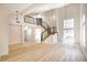 Bright, two-story living room featuring a modern staircase, wood floors, and large windows with natural light at 2204 Brighton Shore St, Las Vegas, NV 89128