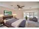 Bright and comfortable main bedroom with large bed, bay windows, and a ceiling fan at 2204 Brighton Shore St, Las Vegas, NV 89128