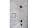 Modern shower featuring marble-patterned tiling, matte black fixtures, and a built-in shower niche at 2204 Brighton Shore St, Las Vegas, NV 89128