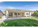 Spacious back patio with covered pergola, concrete flooring, and lush lawn at 2385 Orangeburg Pl, Henderson, NV 89044