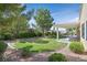 Spacious, landscaped backyard with gravel, mature trees and a covered patio at 2385 Orangeburg Pl, Henderson, NV 89044