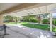 Covered backyard patio with views of spacious lawn and garden at 2385 Orangeburg Pl, Henderson, NV 89044