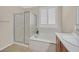 Bathroom features a bathtub, separate shower, and tile flooring at 2385 Orangeburg Pl, Henderson, NV 89044