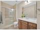 Bathroom with tiled shower featuring glass door, updated vanity, faucet, and toilet at 2385 Orangeburg Pl, Henderson, NV 89044