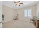 Bright bedroom with neutral tones, carpeted floor, ceiling fan and window with white shutters at 2385 Orangeburg Pl, Henderson, NV 89044
