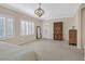 Bright bedroom featuring plantation shutters, neutral carpet, and a modern light fixture at 2385 Orangeburg Pl, Henderson, NV 89044