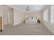 Spacious bedroom with a large window, plush carpet, and neutral decor at 2385 Orangeburg Pl, Henderson, NV 89044