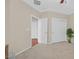 Neutral bedroom features carpeted floor, white trim, closets and doors, and a view into another room at 2385 Orangeburg Pl, Henderson, NV 89044