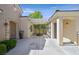 Covered courtyard with garden in center and seating area, with stone and stucco exterior at 2385 Orangeburg Pl, Henderson, NV 89044