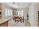 Charming dining area featuring a wooden table, white shutters, and a decorative cabinet at 2385 Orangeburg Pl, Henderson, NV 89044