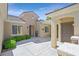 Inviting home entrance featuring a charming courtyard, neutral tones, and manicured landscaping at 2385 Orangeburg Pl, Henderson, NV 89044
