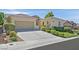 Charming single-story home with a spacious driveway and manicured landscaping at 2385 Orangeburg Pl, Henderson, NV 89044